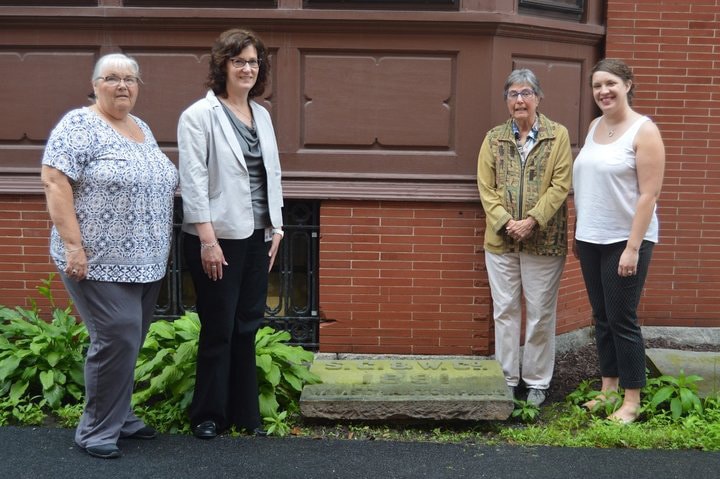 four people posing with scranton stone