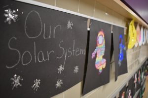 Solar system artwork lining the hallway