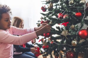 Child decorating Christmas tree
