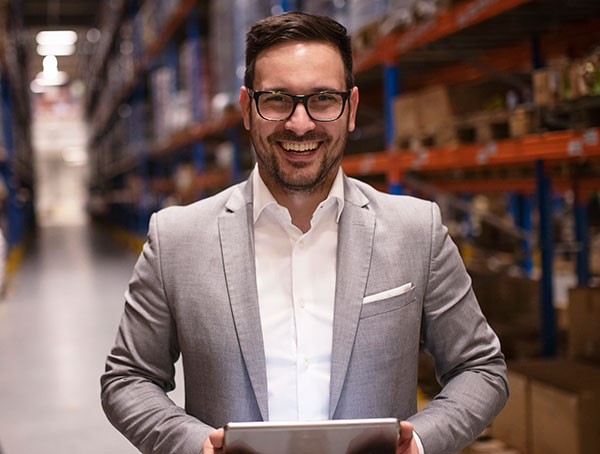 Business man with tablet in warehouse