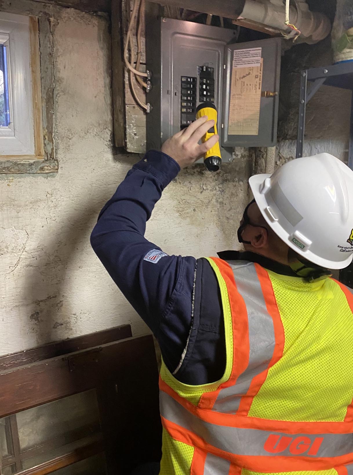 UGI employee inspecting electrical equipment
