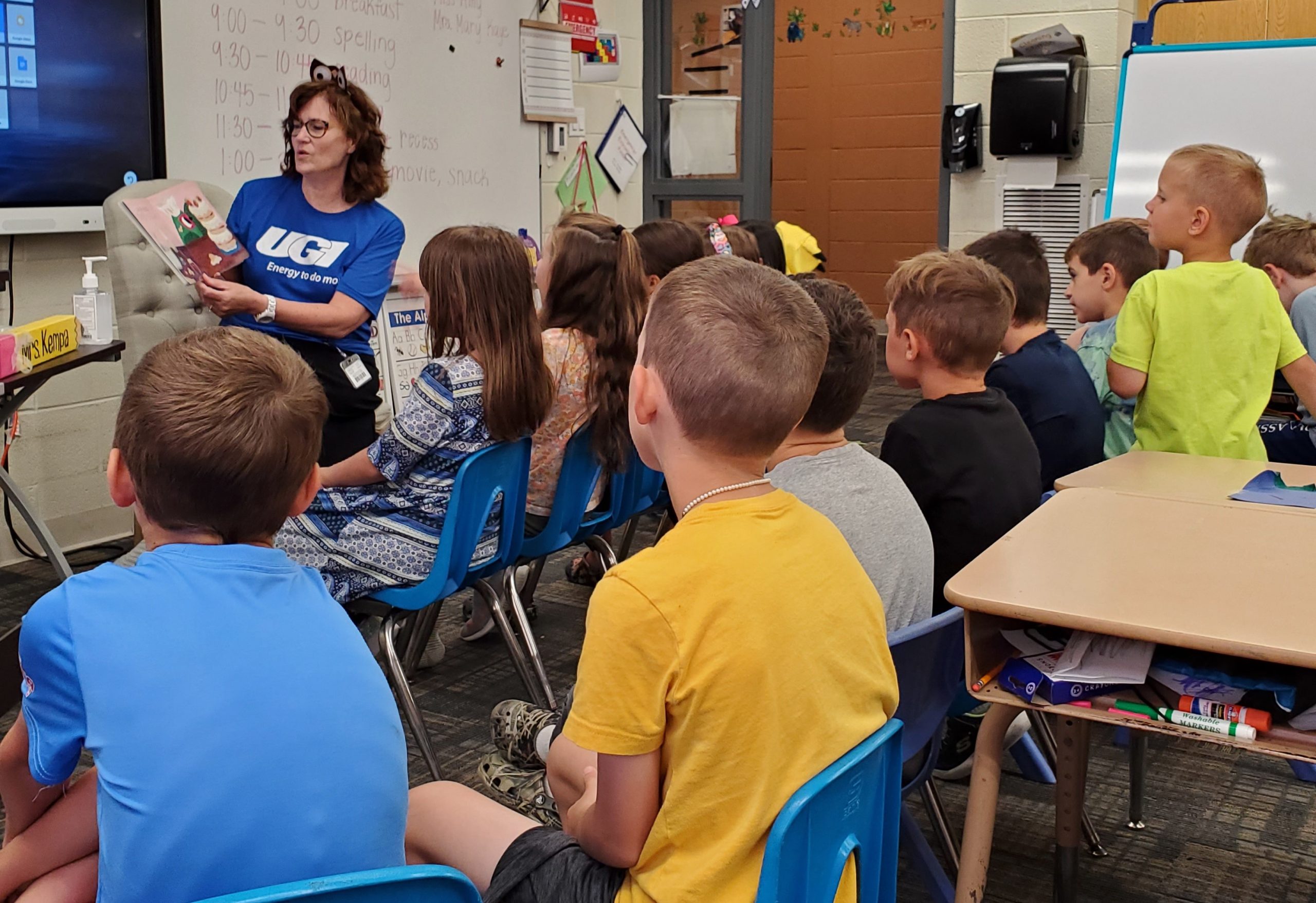 UGI employee reads to classroom of students.