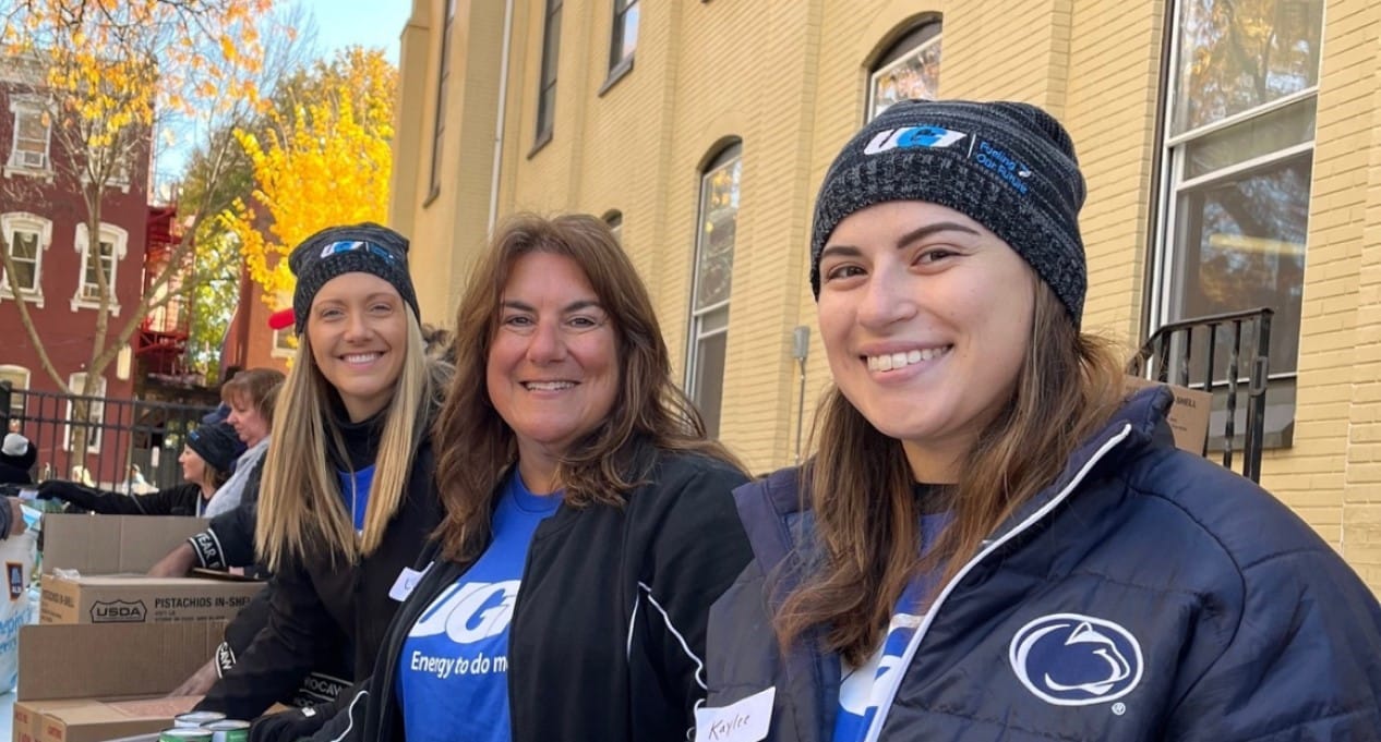 UGI employees hold help to distribute food to community.