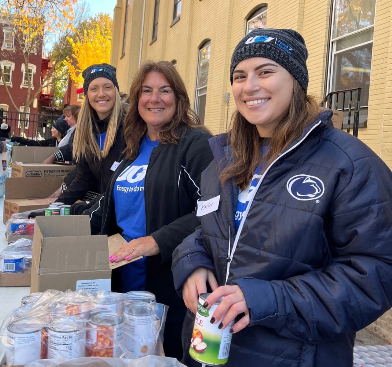 UGI employees hold food to distribute to community.