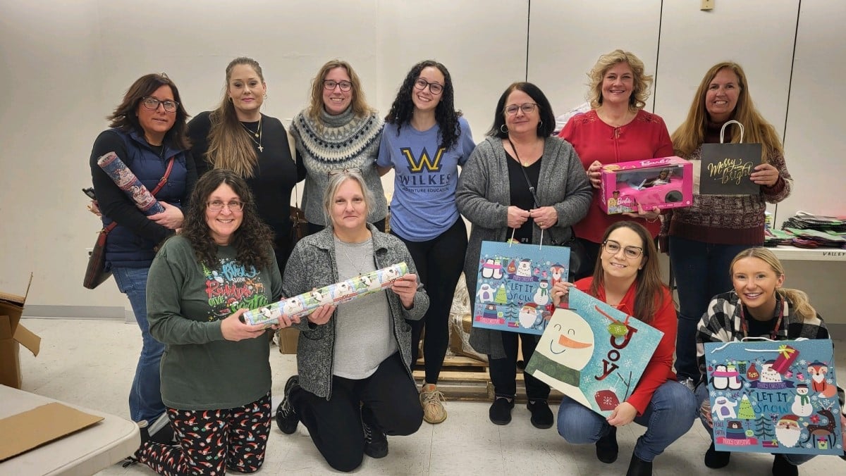 UGI employees pose with gifts they wrapped.