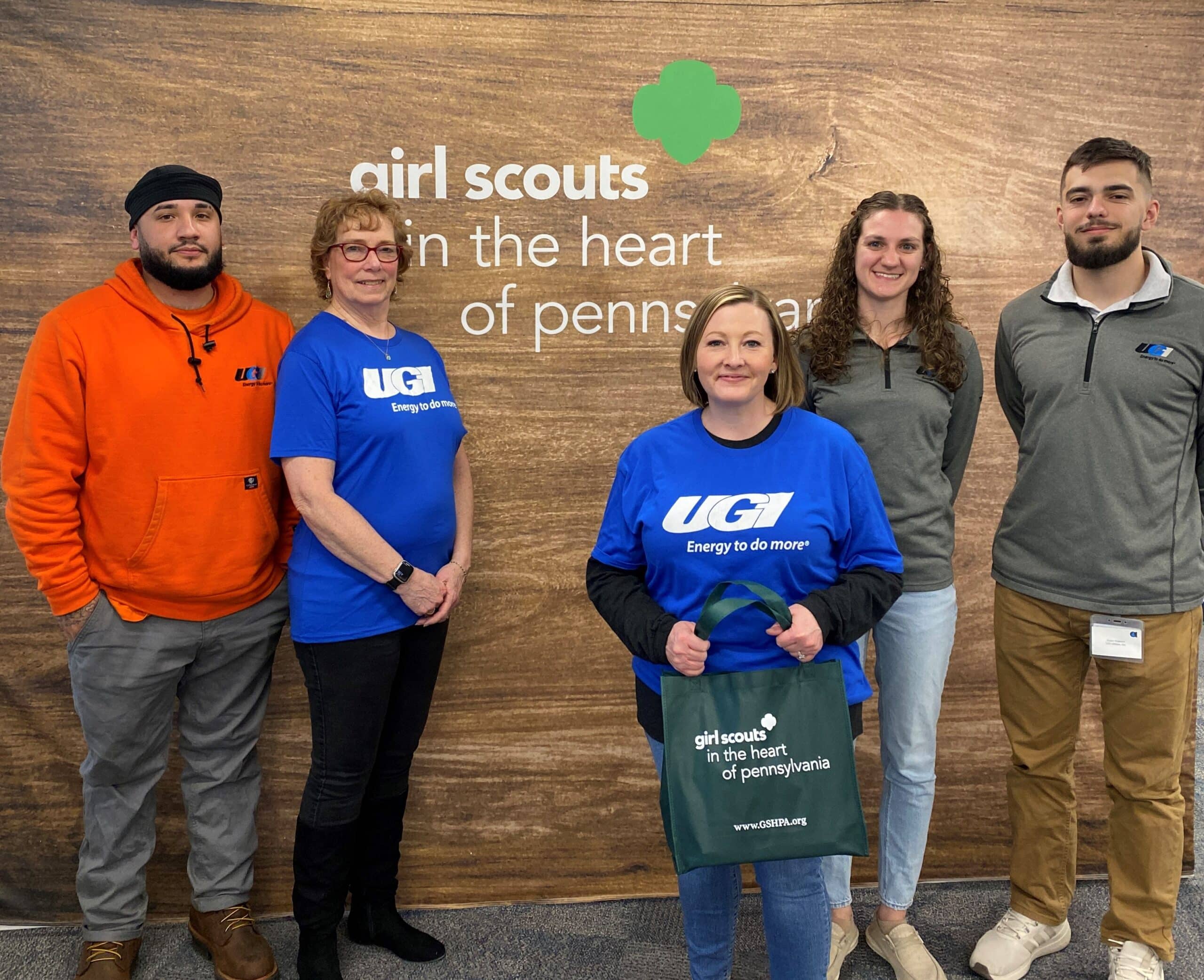 UGI employees stand in front of Girl Scouts in the Heart of Pennsylvania sign.