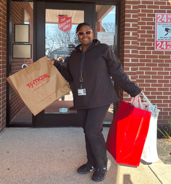 UGI employee holding gift donations outside of Salvation Army.