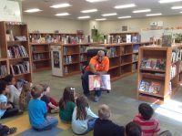 UGI employee reading to kids at the school library