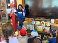 Photo-for-RIF-Program A UGI employee reading a book to young children.