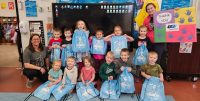 RIF LIteracy Project- Troy Head Start Students and teachers smile with literacy kits.