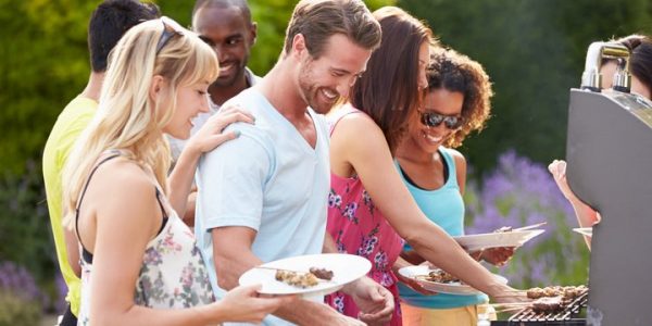 Friends grilling at a party with natural gas grill
