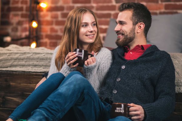 Couple drinking coffee comfortably from the warmth of natural gas furnaces and boilers