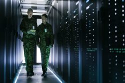 Two Military Men Walking in Data Center Corridor